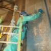 Etching and hand scrubbing of surface before rinsing and coating.